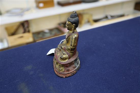 A Sino-Tibetan gilt and polychrome bronze seated figure of Buddha Shakyamuni, 17th/18th century, H. 16.5cm